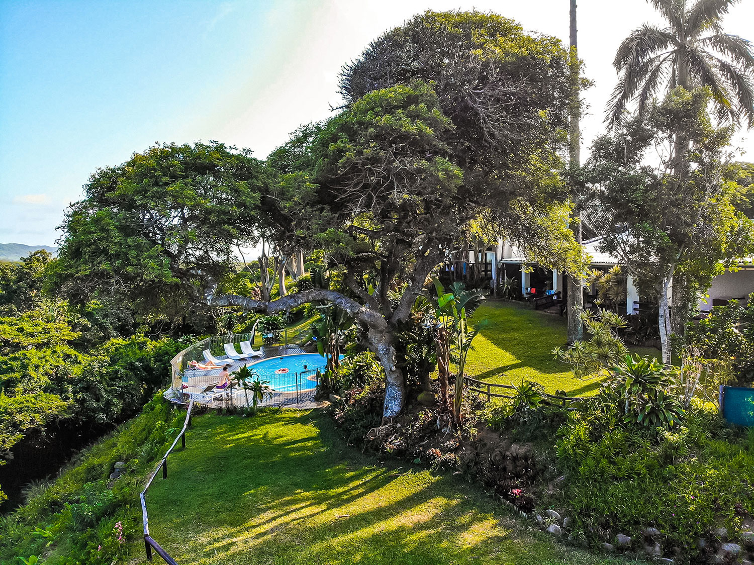 Aerial view of a lodge set in lush coastal forest